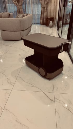 Customer's two-toned Movo Service Trolley with a chrome handle, pictured in a modern living room on a tiled floor.
