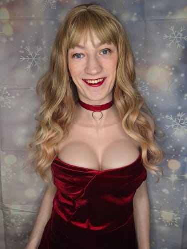 Close-up of a reviewer smiling while wearing the wine red velvet dress, showing the off-shoulder neckline.