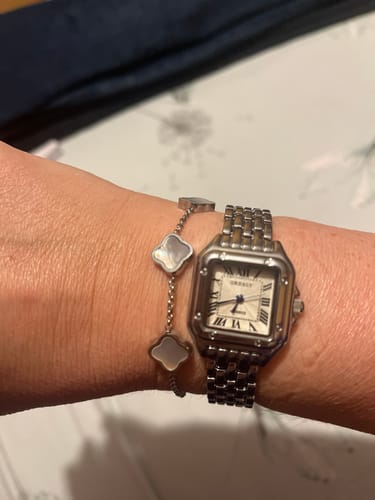 Customer's Vienna Watch on their wrist, showing the square face, blue hands, and metal link band.