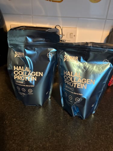 Customer's Black Friday Bundle with two blue pouches of Halal Collagen Protein on a dark counter.