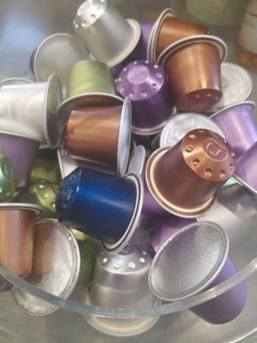Customer's colorful coffee capsules from the Regular Mixed Pack displayed together in a clear bowl.