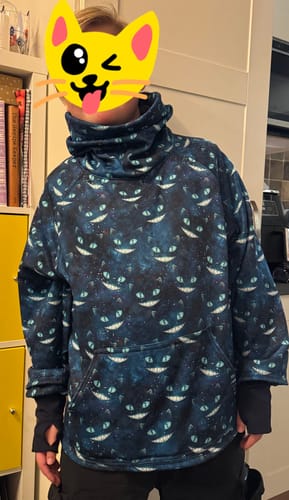 Customer wearing a high-neck sweatshirt made from the dark blue Galaxy Cats fabric.