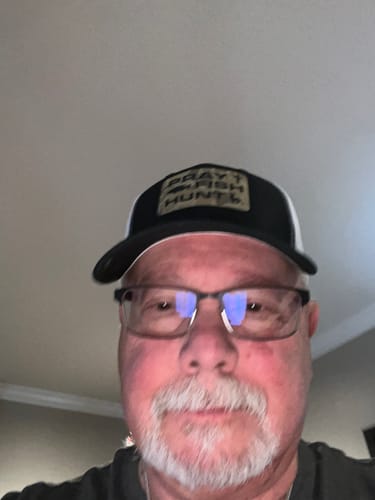 Close-up of a reviewer wearing the black and white Pray Fish Hunt hat.