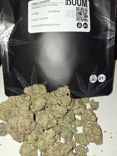 Reviewer's Purple Voodoo flower buds are piled in front of the product's black pouch.