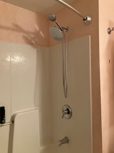 Reviewer's installed chrome Dual Shower Head Set, showing the rain and handheld heads in their shower.