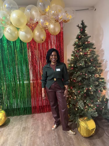 Customer wearing the dark green Lapel Knitted Cardigan buttoned at a festive event.