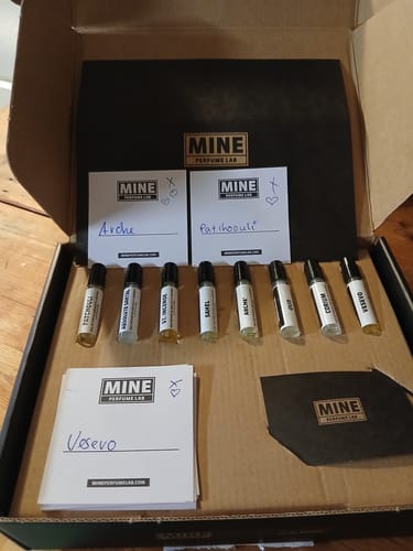 Cliente mostra il set di campioni orientali e legnosi nella sua confezione aperta, con le fiale esposte.