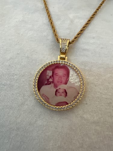Customer's gold-tone Diamond Studded Photo Necklace with a photo of a person and baby inside the round pendant.