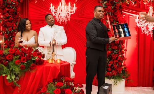 Customers at a wedding reception looking at the presented Lamborghini Oro Vino Spumante Gift Set.