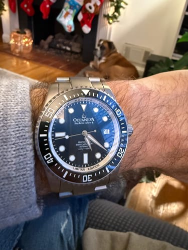 Customer's Oceaneva Deep Marine Explorer II watch on their wrist, showing the titanium band and blue and black dial.