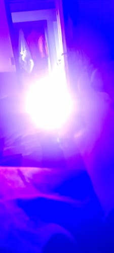 Customer's blurry, overexposed photo with purple light from a review of the REndM Tornado 25000 Puffs.