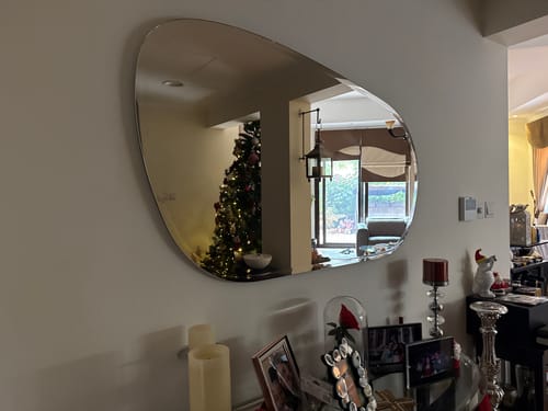 Customer's Decorative Mirror Oa-80108 with a large, asymmetrical shape mounted on a wall in a living room.