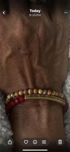 Reviewer's wrist showing the Wooden Jasper stacker bracelet stacked with a red beaded bracelet.