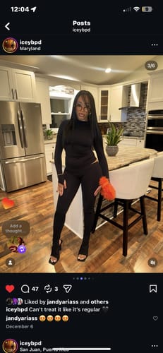 Reviewer standing in a kitchen, wearing the black Seamless Logo Turtleneck as part of a matching set.