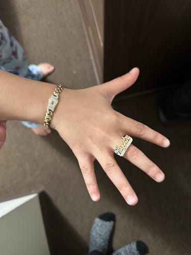 Reviewer showing their wrist with the gold 14K Hollow Cuban Link Bracelet and upgraded zirconia links.