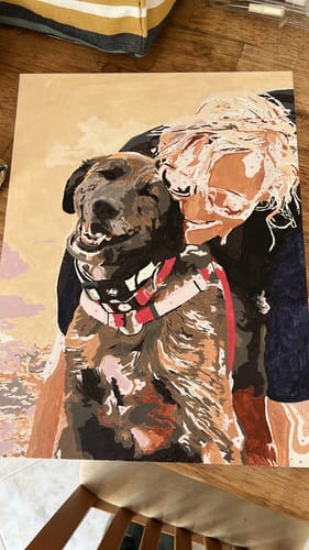 Customer's almost-finished painting from a Custom Paint By Numbers Kit, showing a person hugging a dog.