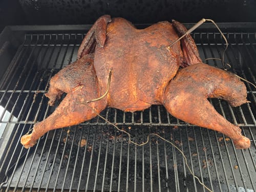 Customer's smoked turkey, prepared using the brine kit, on a grill with temperature probes.