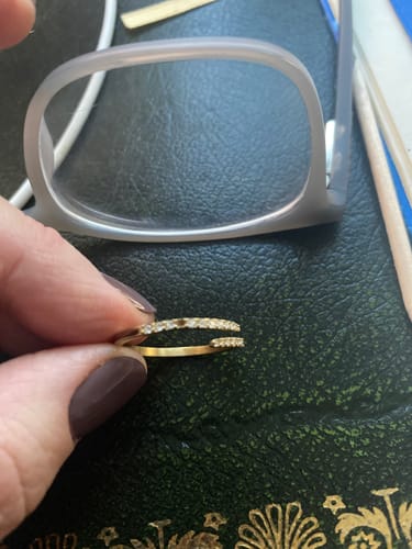 Customer holding the gold CZ Wrap Ring, showing a missing stone in the pave setting.