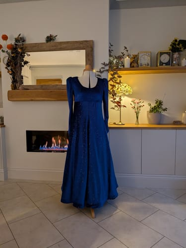 Reviewer's finished long dress made from the sparkly blue velvet fabric, shown on a mannequin.