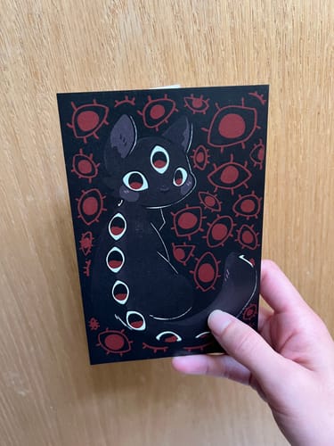 Customer photo review of Creepy Cat Eyes Postcard!
