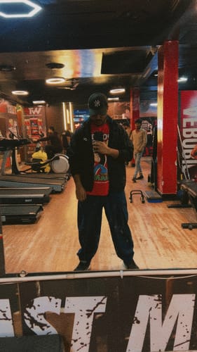 Reviewer wearing dark Boxate Yoga Pants while taking a mirror selfie in a gym.