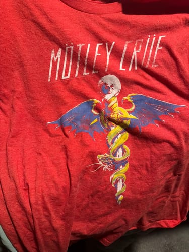 Customer's soft red Dr. Feelgood T-Shirt with its vintage graphic laid out.