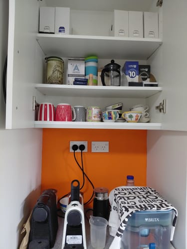 Reviewer's box of Blend 10 coffee on a shelf in their kitchen coffee station.