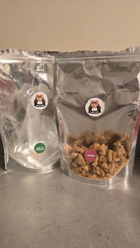 Customer shows two Big 'n' Mix pouches: an empty Salt & Vinegar bag and a half-full Bacon bag on a counter.