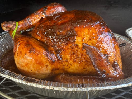 Customer's smoked turkey, looking golden and glazed, after using the Turkey Brine Kit in a pan.
