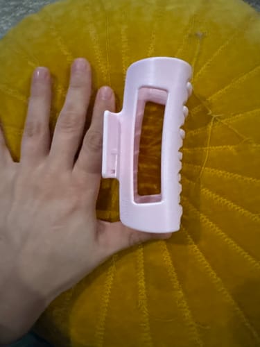 Customer holding the large, light pink cloud clip in their hand to show its scale.