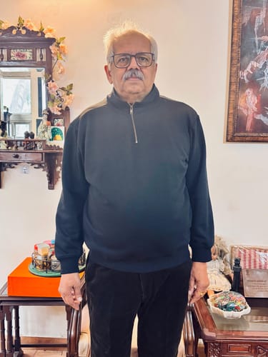 Reviewer standing indoors wearing the Unisex Navy Blue Zip Neck Sweatshirt, providing a full view of its fit.