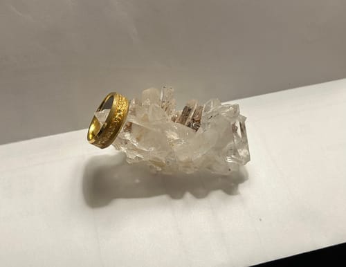 Customer's textured gold Aureum ring resting on a clear crystal cluster.