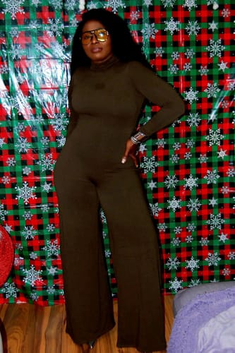 Reviewer stands with hand on hip, wearing the dark NW Sculpt Wide-Leg Jumpsuit.
