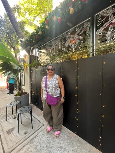 Reviewer standing outdoors in the brown, balloon-style Bubblin' Yoga Pants.