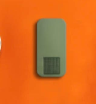 Customer's green Nano Case shown from above on a bright orange surface.