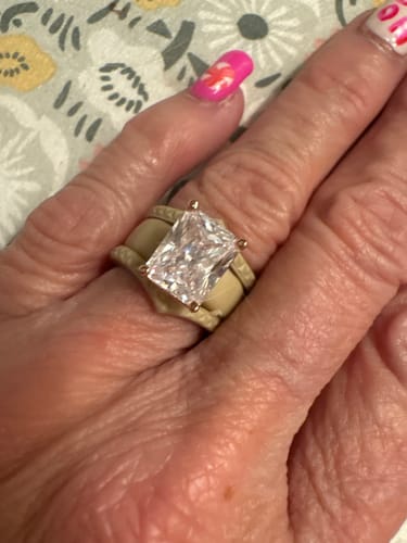 A close-up of a customer wearing the GlowStone silicone ring with a large emerald-cut CZ.