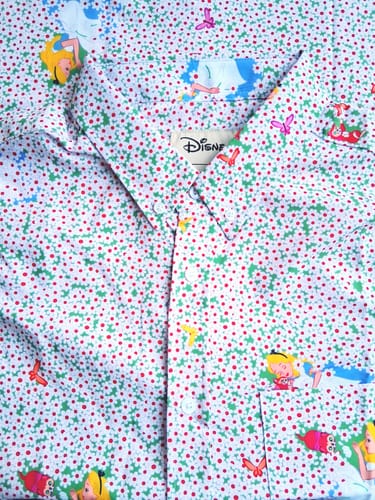 Close-up of a reviewer's Disney Alice in Wonderland shirt, showing the colorful pattern with Alice and butterflies.