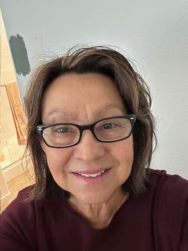 A smiling customer, aged 75, who feels energized from using Boomer Boost.