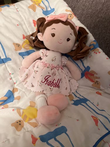 Reviewer's soft Personalized Princess Breeze doll, with the name Isabill embroidered on its floral dress.