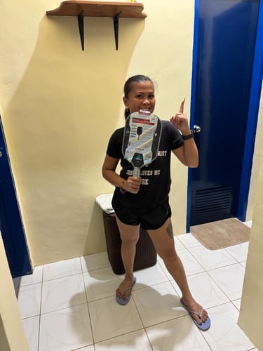 Customer happily holding their new JOOLA Ben Johns Perseus Pro IV Pickleball Paddle in its packaging.