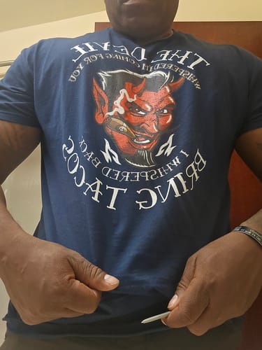 Reviewer wearing the dark blue 'Devil Whispered...Bring Tacos' OG T-Shirt.