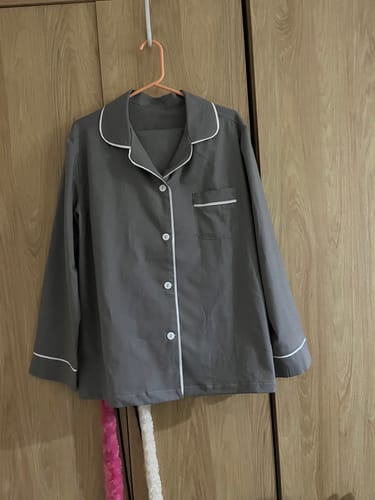 Reviewer's finished grey pajama top with white trim, sewn from Plain 100% Cotton Fabric, hanging up.