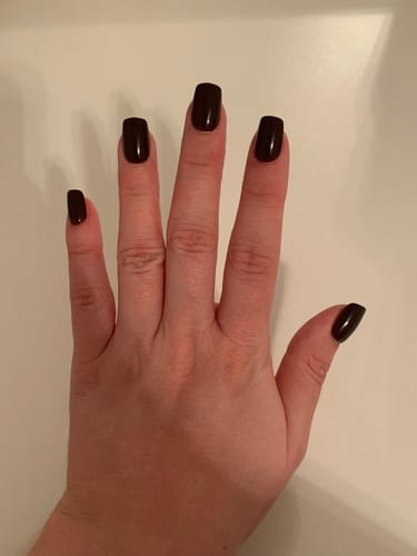Reviewer's hand showing the short, square Cherry Cola Press On Nails against a white background.