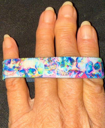 Customer showing the colorful skull design on their 1 Mystery ZOX wristband.