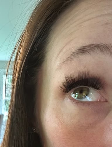 Close-up of a customer's eye wearing full, curly Fluffy® Gossamer® Lashes.