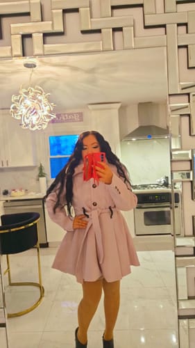 Reviewer taking a mirror selfie in the pink Elysian Coat, showing off the belted waist.
