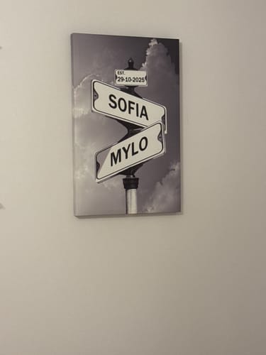 Customer's 'COUPLES DATE OF LOVE' canvas with street signs for 'SOFIA', 'MYLO', and date '29-10-2025' on a wall.