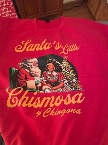 Reviewer's red 'Santa's Favorite Chismosa Navidad Sweater' with a graphic of Santa and a woman.