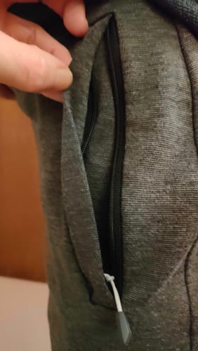 Customer shows a close-up of a welt zipped pocket on grey lounge pants made from the Plain Ponte Roma Fabric.