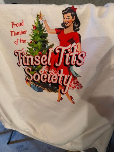 Customer's white Tinsel Society Sweatshirt, showing the vintage-style graphic with text 'Proud Member of the Tinsel Tits Society'.
